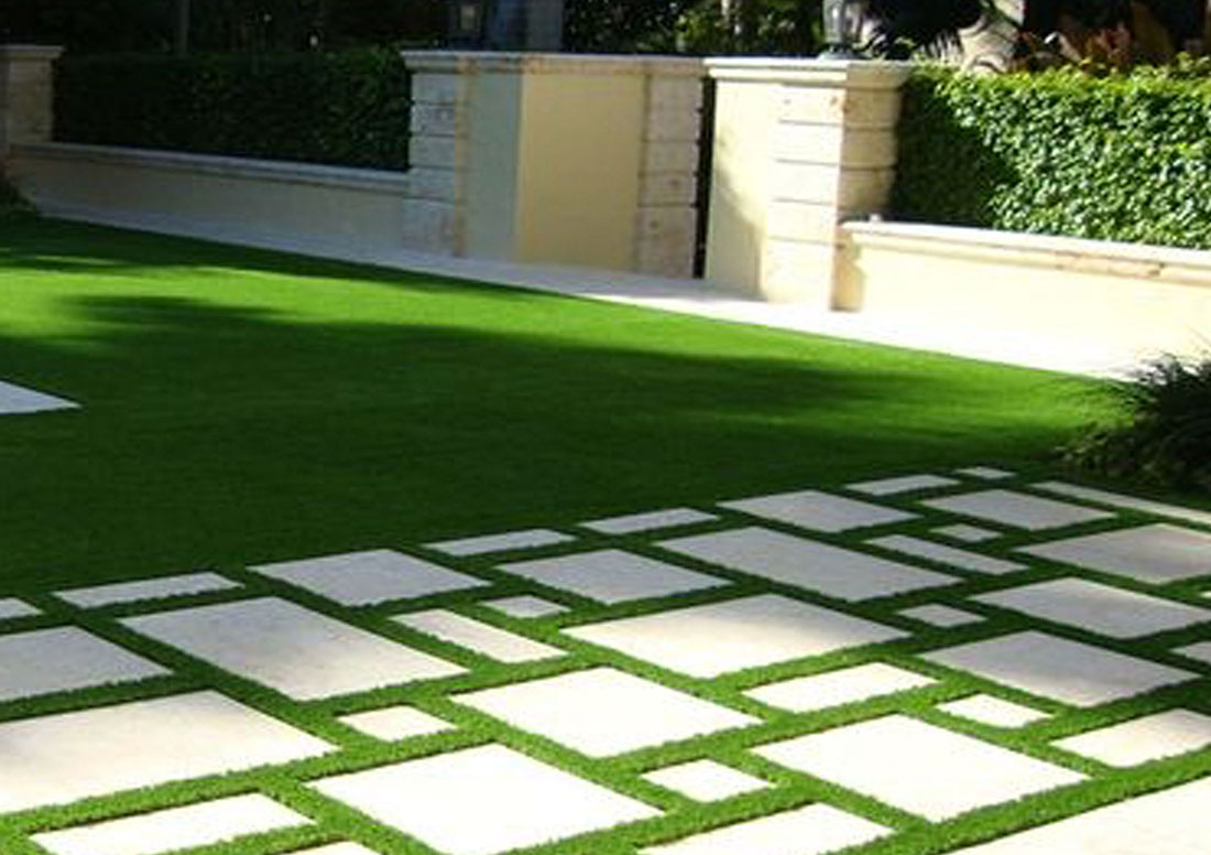 intricate stone pathway patio with artificial turf